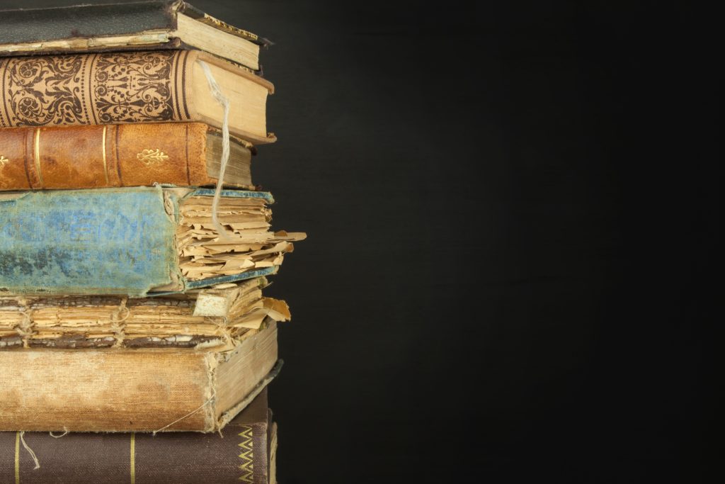 Close up shot of old books in a pile