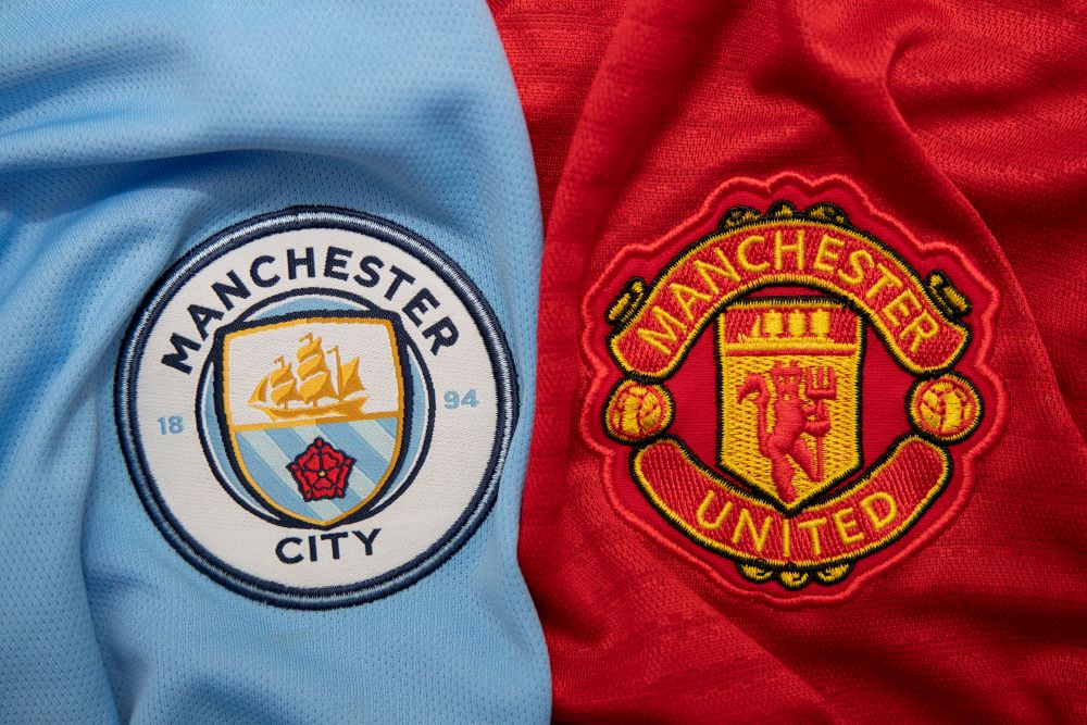 Manchester City and Manchester United football kit side by side