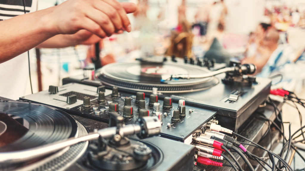 close up of a dj playing outdoors